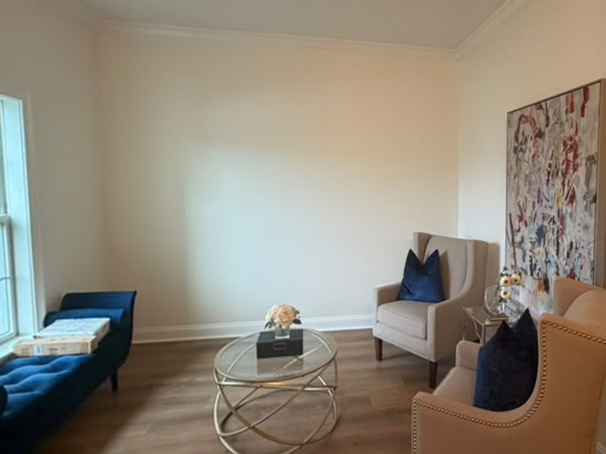 Sitting room accent wall with new picture-frame molding painted a warm greige — before