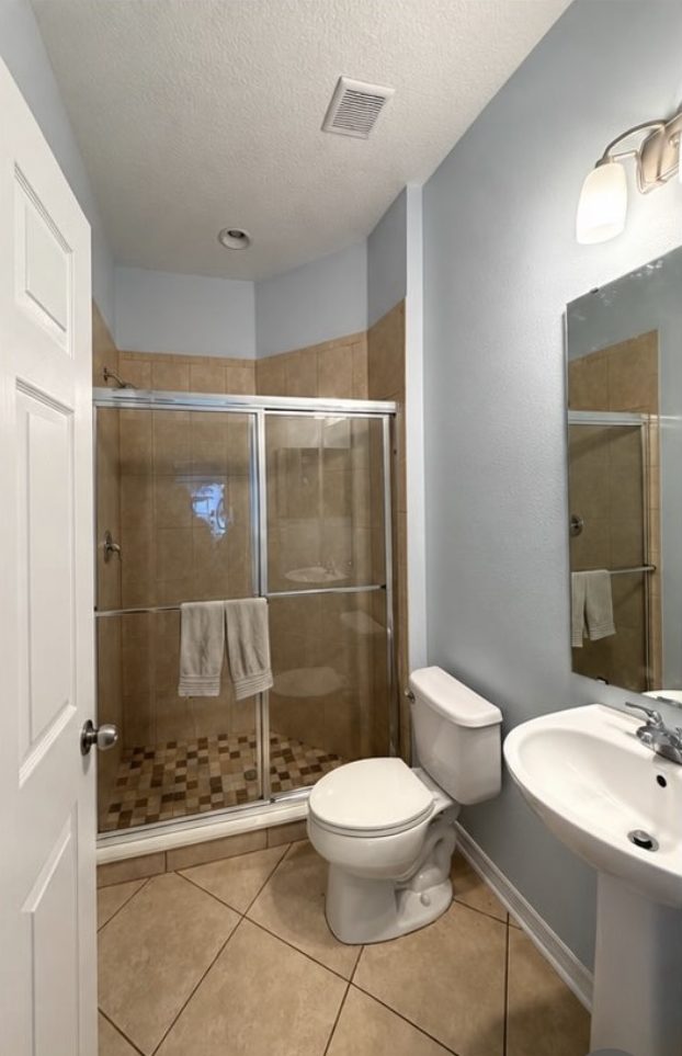 Bathroom repainted from beige to soft blue — after