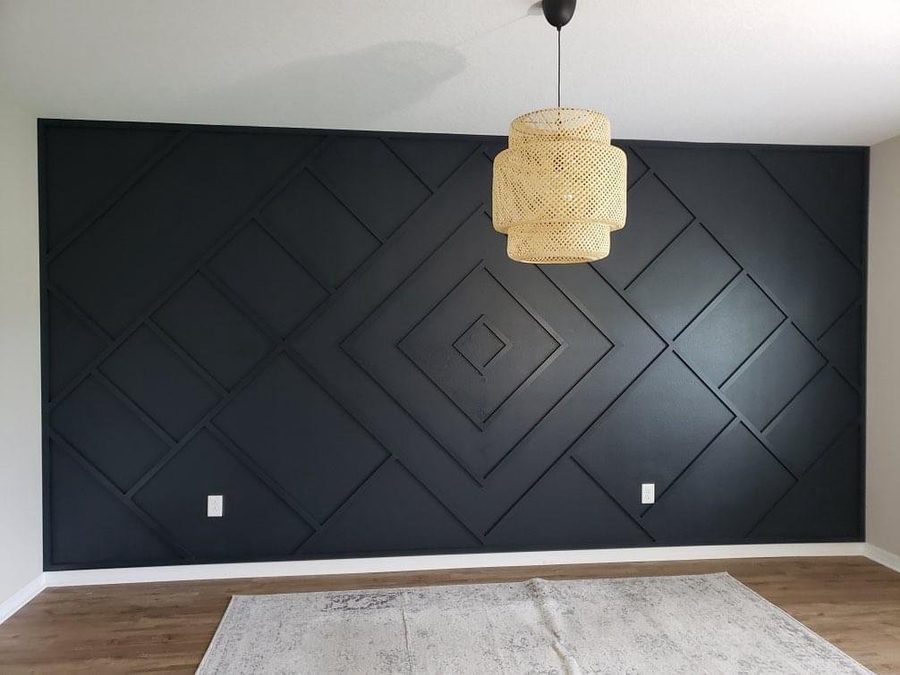 Matte black geometric accent wall with diamond trim pattern