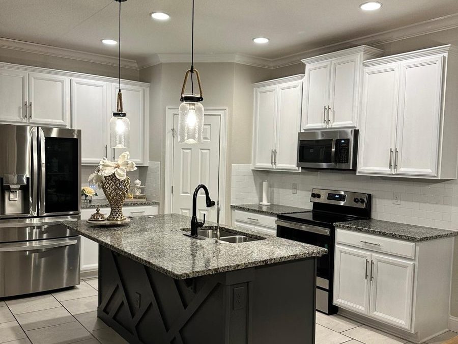 Kitchen with white cabinets and a charcoal island