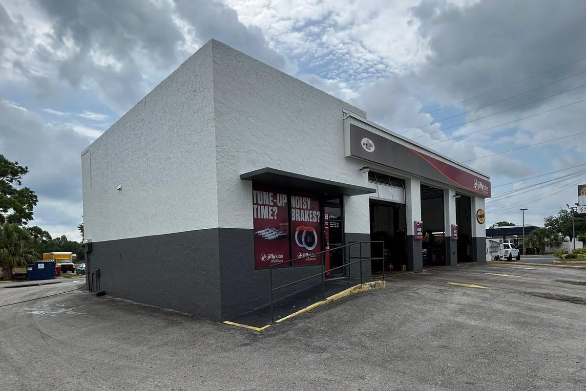Auto service center in Central Florida freshly repainted white with a charcoal base