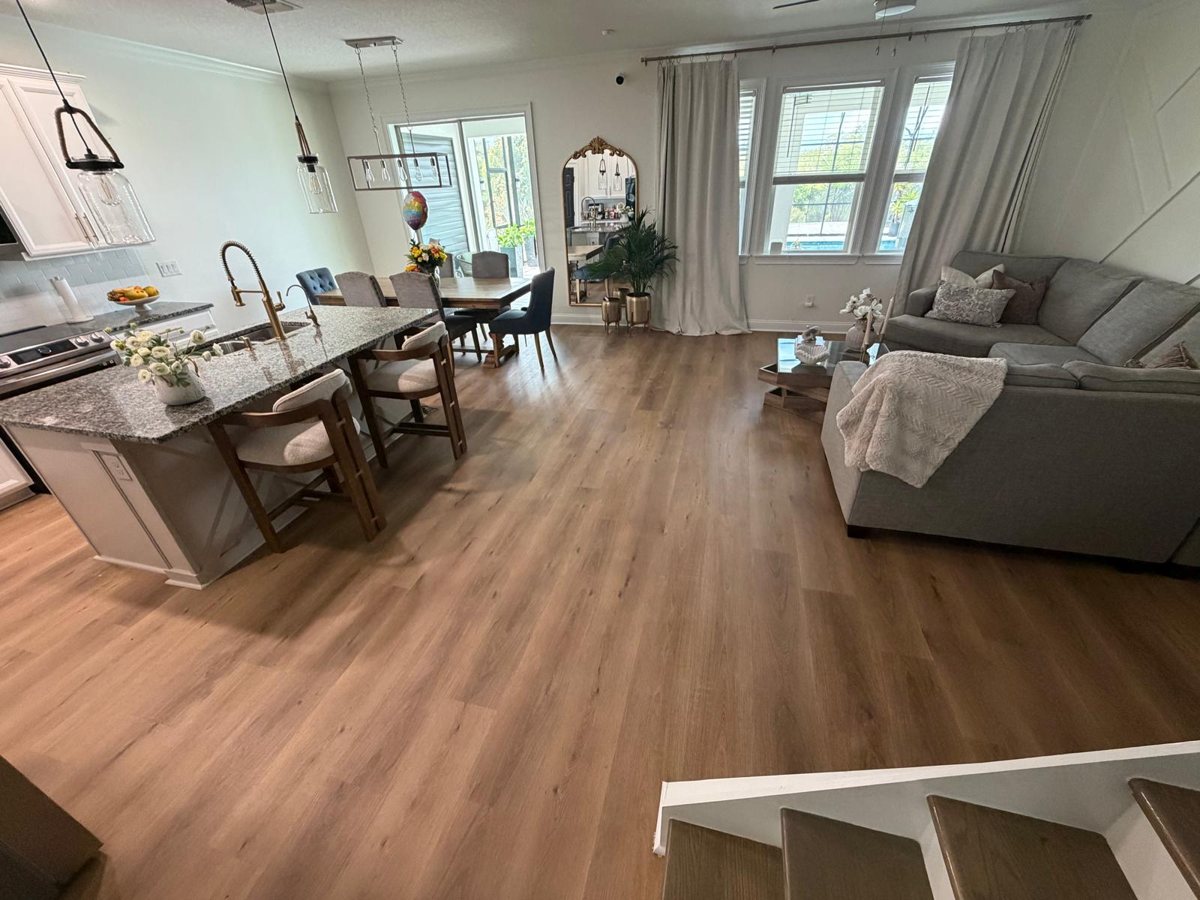 Open kitchen, dining and living area with new wood-look laminate flooring