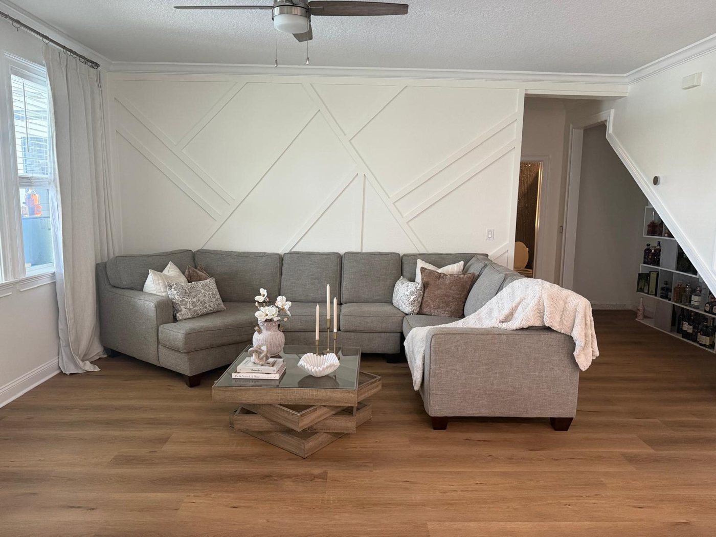 Bright white living room with a painted geometric board-and-batten accent wall